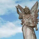 Cemetery angel with a sky on the background