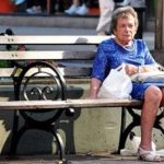 An old woman sitting on a bench